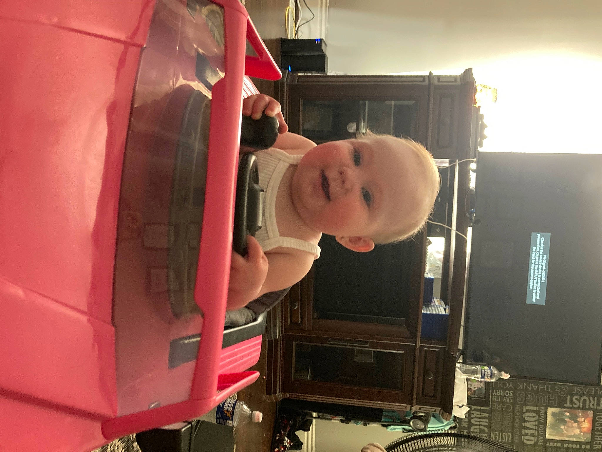 Brynlee is registered to the contest to win money with this photo: auto_part, automotive_design, automotive_exterior, automotive_lighting, automotive_tire, automotive_wheel_system, baby, baby_products, baby_toddler_clothing, dress, fender, helmet, hood, machine, magenta, person, smile, tire, toddler, vehicle_door