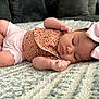 baby, sleeping, bow, onesie, blanket, infant, cute, peaceful, cozy, soft, face, hand, legs, pink, brown, pattern, headwear, indoor, portrait, child