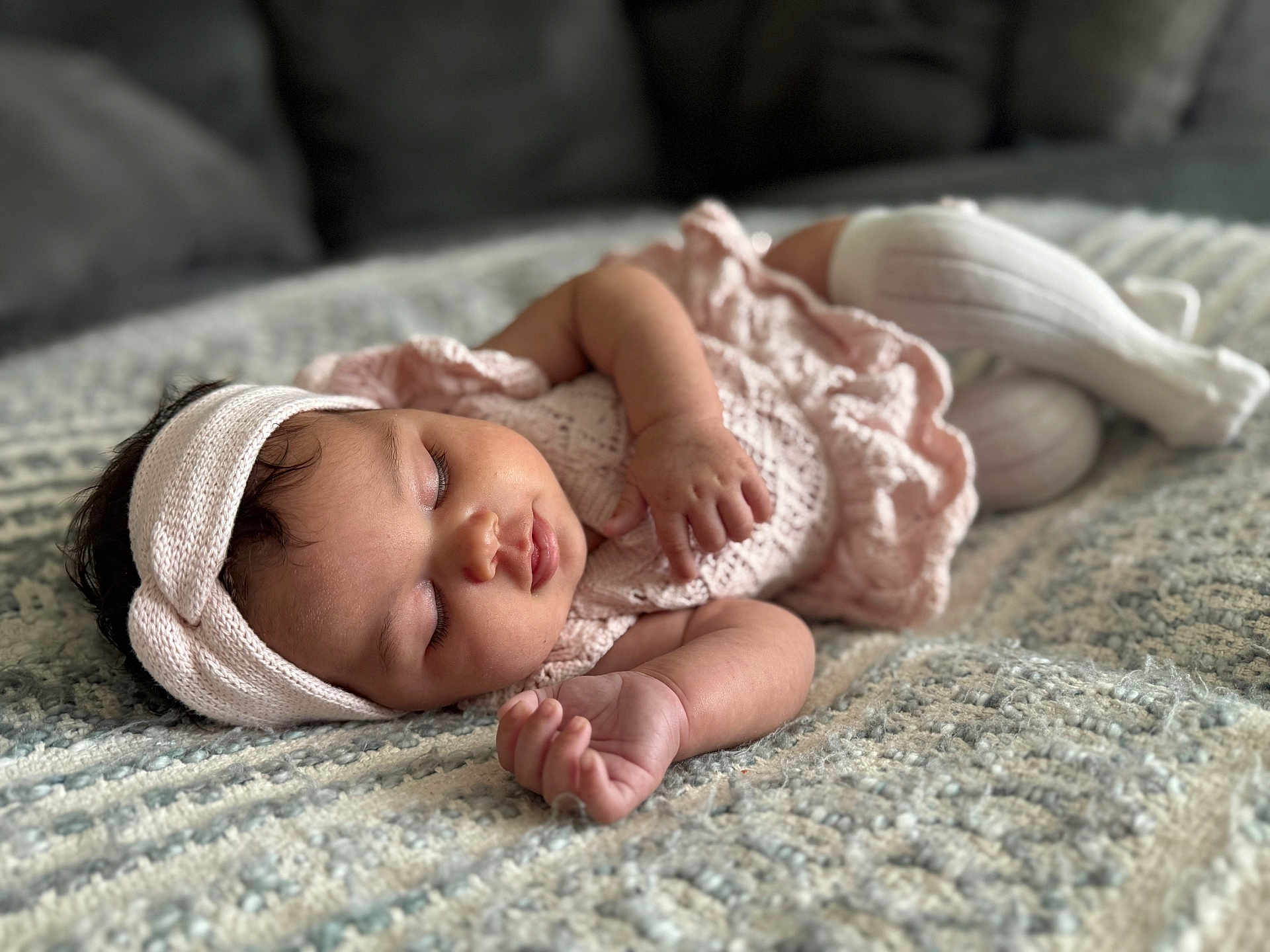 Skyla is registered to the contest to win money with this photo: baby, sleeping, infant, blanket, headband, pink_clothing, knitwear, soft_light, closeup, peaceful, child, portrait, indoor, curls, cozy, texture, cute, resting, toddler, hand