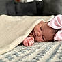 Skyla is registered to the contest to win money with this photo: baby, sleeping, blanket, pink_bow, infant, cozy, closeup, face, hand, soft_texture, peaceful, cute, indoors, resting, child, portrait, bedroom, warm, newborn, comfort