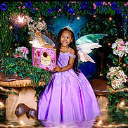 Milanie is registered to the contest to win money with this photo: child, girl, fairy_wings, lavender_dress, princess_crown, book, mushrooms, flowers, greenery, forest, fantasy, magic, sparkles, smiling, long_hair, indoor, portrait, costume, happy, imaginative