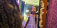 Milanie is registered to the contest to win money with this photo: child, girl, mirror, princess_dress, tiara, braided_hair, flower_garland, pout, reflection, indoor, decor, pink_flowers, greenery, lamp, curtains, room, plants, playful, portrait, dress