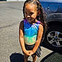 Milanie joined the competition — help win amazing prizes! child, girl, braided_hair, smile, leotard, skirt, outdoor, sunlight, car, vehicle, pavement, shadow, happy, standing, jewelry, gold_chain, footwear, crocs, urban, daytime