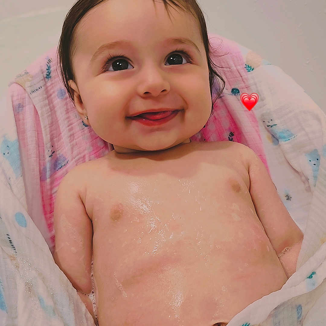 Carla is registered to the contest to win money with this photo: baby, bath, blanket, child, childhood, cute, expression, face, happy, head, indoors, infant, person, portrait, skin, small, smiling, towel, water_drops, wet_skin