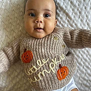 Devonte joined the competition — help win amazing prizes! baby, infant, smiling, sweater, knitted, pumpkin, cute, lying_down, white_blanket, closeup, child, portrait, happy, face, eyes, mouth, button, clothing, soft_texture, adorable