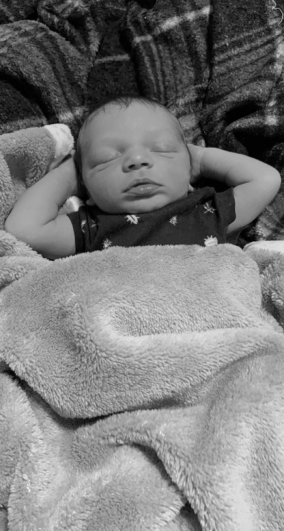 Makai is registered to the contest to win money with this photo: baby, black_and_white, cheek, comfort, eye, facial_expression, finger, flash_photography, grass, grey, happy, human, iris, monochrome, monochrome_photography, organ, person, skin, style, toddler