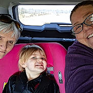 Josliyn joined the competition — help win amazing prizes! child, adult, car_seat, vehicle, glasses, smile, person, window, road, seatbelt, pink, hair, face, jacket, sunglasses, inside, travel, happy, family, portrait