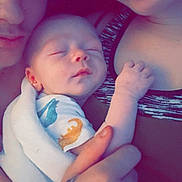 Waylon is registered to the contest to win money with this photo: baby, sleeping, adult, hand, tattoo, closeup, family, skin, clothing, blanket, face, portrait, comfort, love, rest, cuddle, person, indoor, relax, toddler