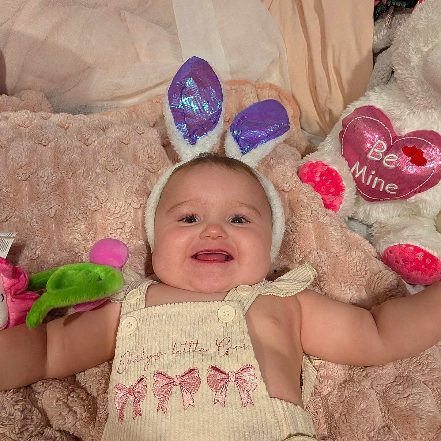 Kamden is registered to the contest to win money with this photo: baby, bunny_ears, smiling, plush_toys, blanket, pink, white_bear, heart, cute, child, infant, toy, cozy, happy, face, clothing, indoors, person, soft_texture, playful