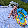 Kimberlynn joined the competition — help win amazing prizes! baby, child, infant, grass, blanket, inflatable_pool, umbrella, laundry_basket, outdoor, play, summer, toy, colorful, happy, smiling, sitting, cute, clothing, person, nature