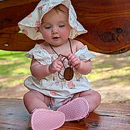 Kimberlynn is registered to the contest to win money with this photo: baby, bench, child, clothing, curious, cute, hat, infant, nature, necklace, outdoor, pink_shoes, portrait, sitting, strawberry_pattern, summer, sun_hat, sunlight, wood, wooden_pendant