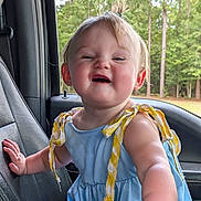 Kimberlynn is registered to the contest to win money with this photo: blue_dress, car_seat, child, cute, daylight, forest, hand, happy, infant, lemon_pattern, nature, outdoor, person, pony_tail, portrait, seat, smiling, toddler, trees, window