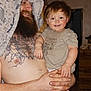 Sapphire is registered to the contest to win money with this photo: adult, beard, child, indoor, man, smiling, toddler, tattoo, shirtless, towel, holding, person, furniture, wooden_floor, cabinet, clothing, happy, portrait, family, home