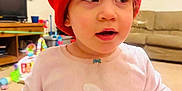 Ana'Leigh Rose joined the competition — help win amazing prizes! toddler, child, red_hat, sweater, polar_bear, indoor, living_room, toy, couch, television, furniture, carpet, cute, person, headwear, smiling, baby, young_child, room, casual