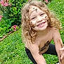 child, mud, smile, curly_hair, outdoor, garden, flowers, greenery, grass, play, happy, nature, face_paint, bare_chest, window, brick_wall, plant, spring, fun, daylight