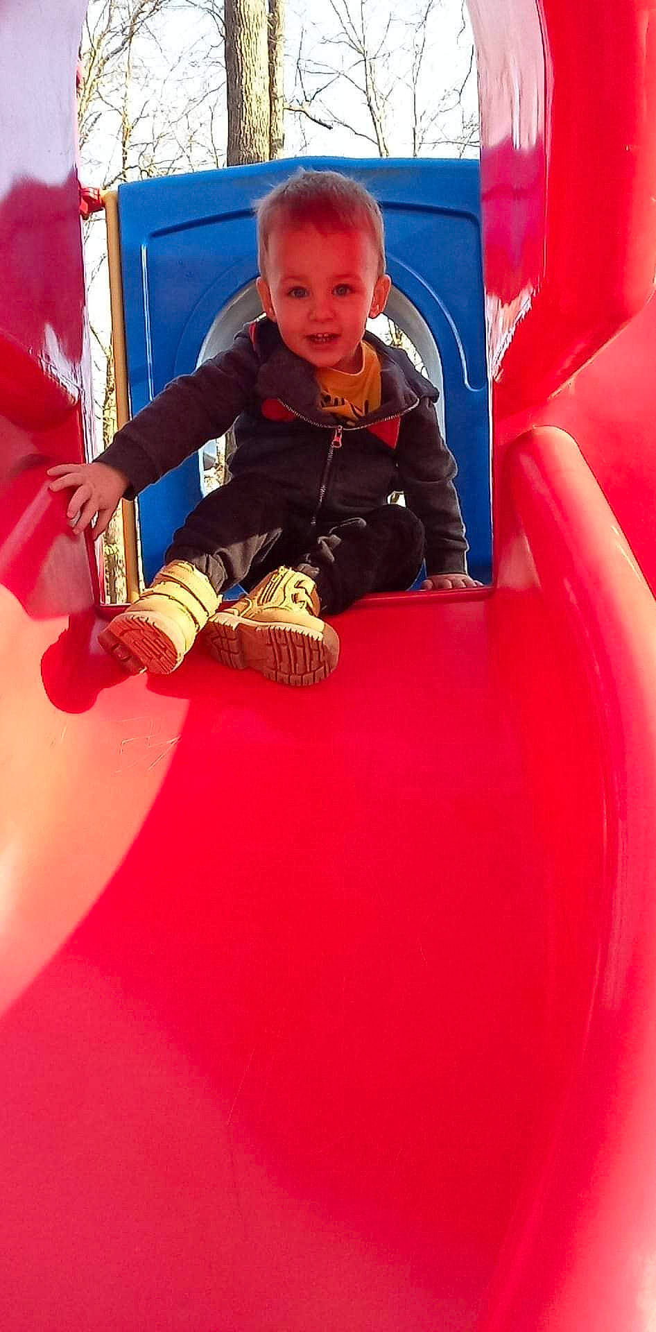 Gage is registered to the contest to win money with this photo: baby, baby_toddler_clothing, bounce_house, child, chute, comfort, electric_blue, flooring, fun, inflatable, leisure, magenta, outdoor_play_equipment, person, play, playground, recreation, red, sitting, smile