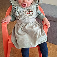 Anna participe au concours pour gagner de l'argent avec cette photo : blue_eyes, child, cute, dress, flooring, flower_decorations, furniture, girl, happy, indoor, navy_tights, orange_chair, pigtails, portrait, seated, smiling, squirrel_embroidery, toddler, white_sandals, wooden_floor
