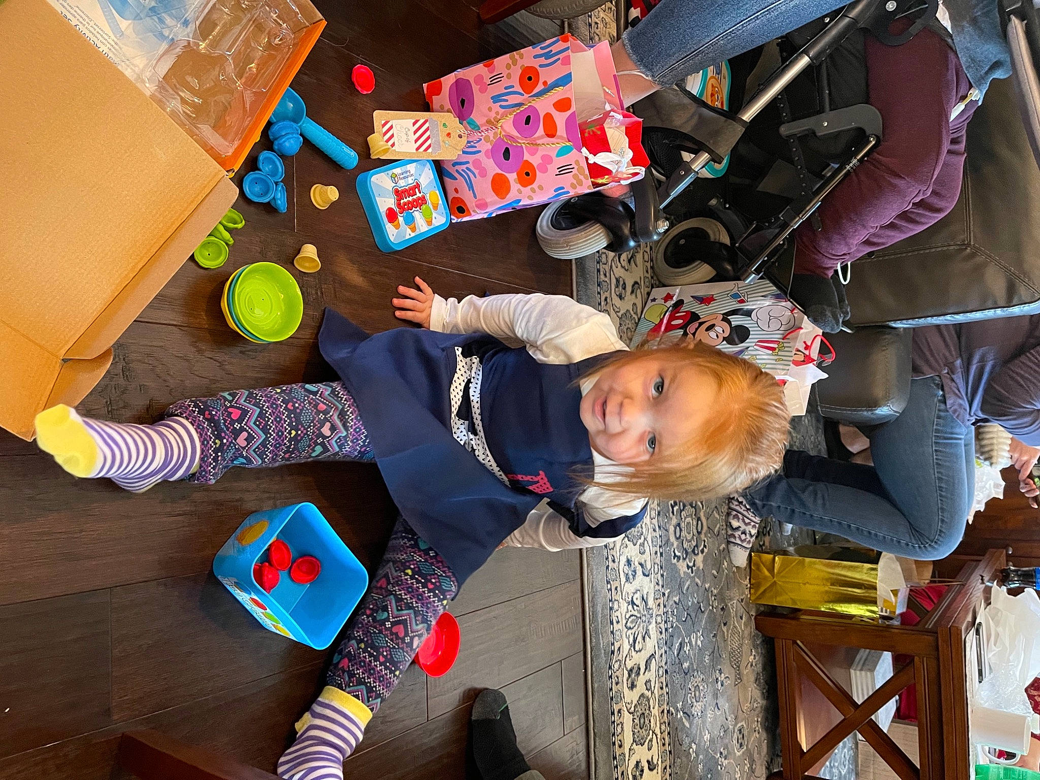 Jacinda joined the competition — help win amazing prizes! art, child, flooring, fun, happy, hardwood, leisure, pattern, person, play, public_space, sandal, shipping_box, shoe, smile, sock, toddler, wood