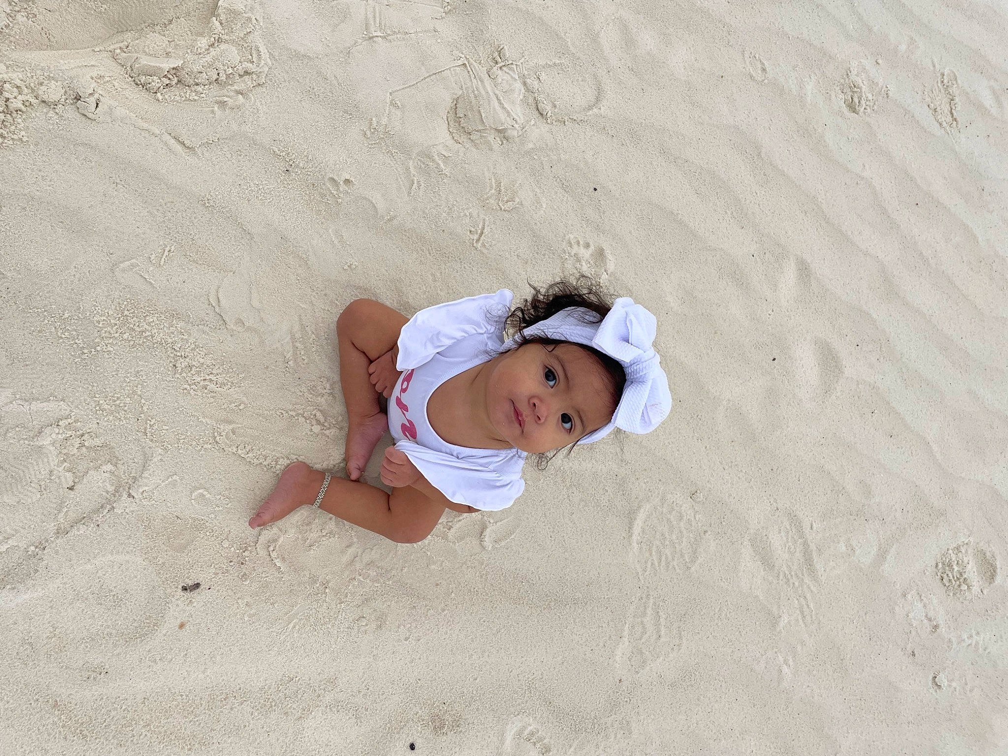 Araceli joined the competition — help win amazing prizes! baby, barefoot, beach, body_of_water, eye, flooring, foot, fun, grass, happy, headgear, headwear, landscape, leisure, people_in_nature, people_on_beach, person, sand, shadow, sitting