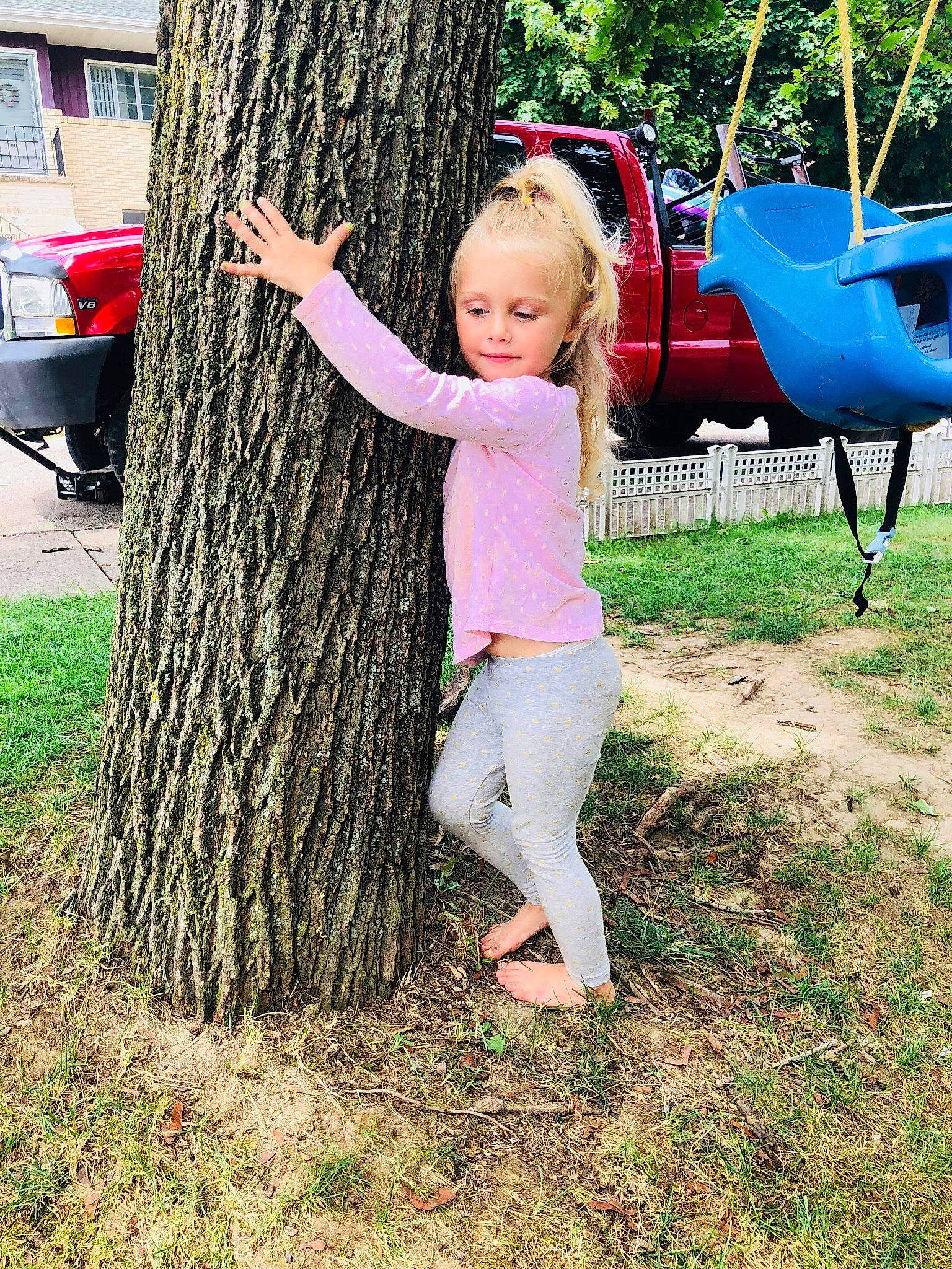 Roxy is registered to the contest to win money with this photo: backyard, child, fun, girl, grass, lawn, leisure, outdoor_play_equipment, person, plant, play, playground, public_space, recreation, sitting, summer, swing, toddler, tree, vacation