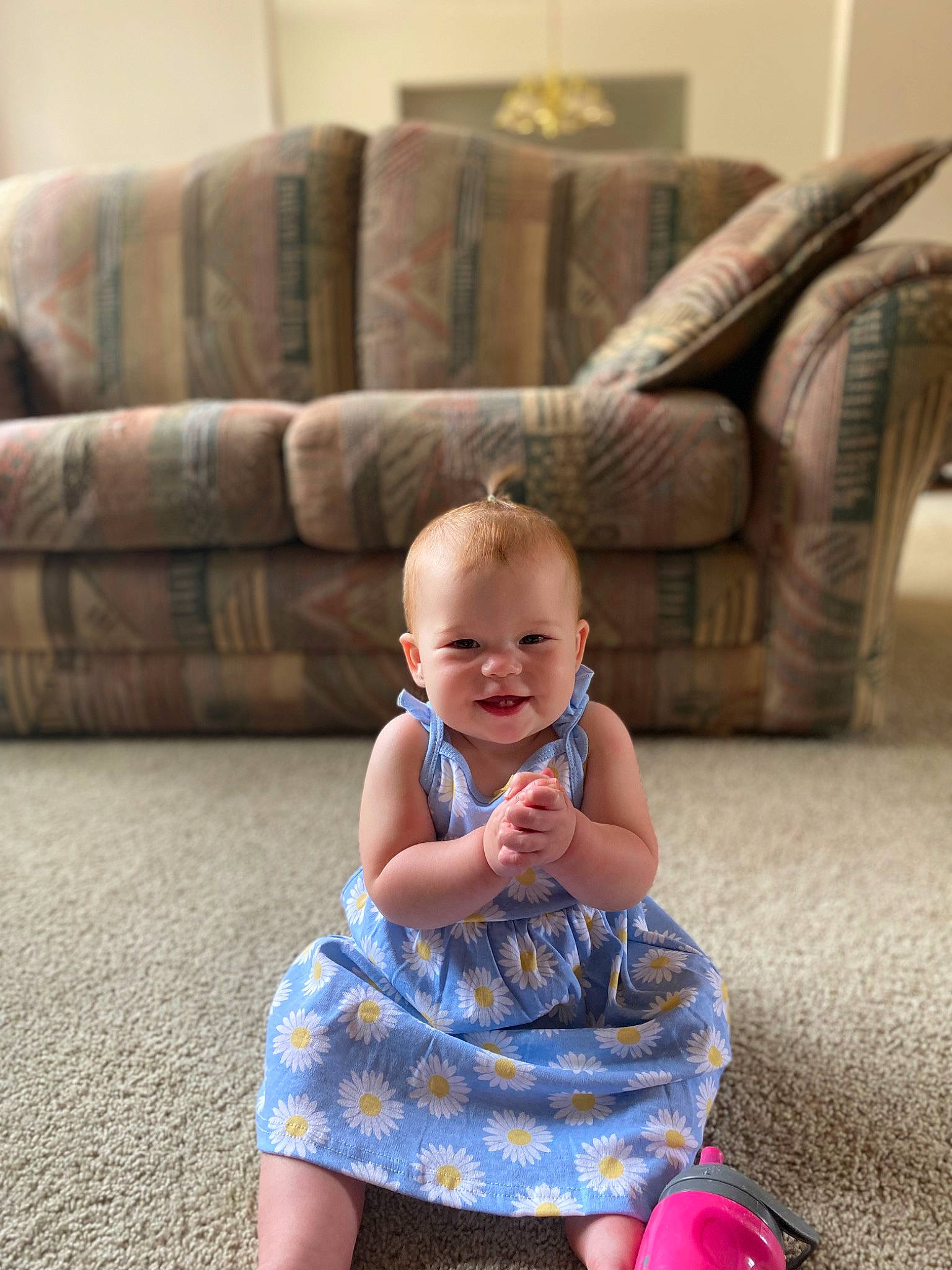 Charlee is registered to the contest to win money with this photo: baby, baby_toddler_clothing, child, comfort, couch, dress, electric_blue, floor, flooring, fun, happy, hardwood, joy, leisure, living_room, morning, person, purple, sitting, smile