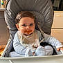 Nasser a rejoint le concours — aidez-le/la à gagner de superbes lots ! baby, high_chair, bib, food_stain, messy_face, striped_pajamas, indoor, kitchen, child, feeding, cute, smiling, person, seat_belt, hair, face, expression, table, dish, cooking_utensils