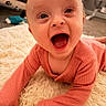 baby, infant, smiling, happy, mouth_open, pink_clothing, long_sleeves, lying_down, carpet, fluffy_rug, indoor, child, cute, portrait, person, young_child, head, face, expression, skin