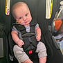 Weston is registered to the contest to win money with this photo: baby, infant, car_seat, straps, feeding_tube, face, clothing, foot, hand, sitting, expression, indoor, child, person, safety, seat_belt, warning_label, closeup, cute, newborn