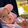 baby, child, pink_hat, pink_jacket, hands, outdoor, pond, flamingo, nature, curious, wide_eyes, portrait, close_up, infant, cute, summer, sunlight, animal, water, reflection