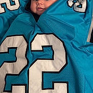 Gabriella joined the competition — help win amazing prizes! 22, baby, blue, child, closeup, clothing, cute, eyes, fabric, face, head, indoor, infant, jersey, number, person, portrait, smiling, sportswear, textile