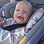 baby, car_seat, smile, infant, child, seatbelt, clothing, happy, portrait, person, interior, car, cushion, cute, young_child, seat, safety, child_in_car, infant_clothing, joy