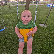Legand joined the competition — help win amazing prizes! baby, child, swing, park, grass, sunset, outdoor, green_shirt, yellow_swing, playground, tree, car, fence, person, infant, summer, nature, leisure, baby_clothes, recreation