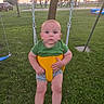 baby, child, swing, park, grass, sunset, outdoor, green_shirt, yellow_swing, playground, tree, car, fence, person, infant, summer, nature, leisure, baby_clothes, recreation