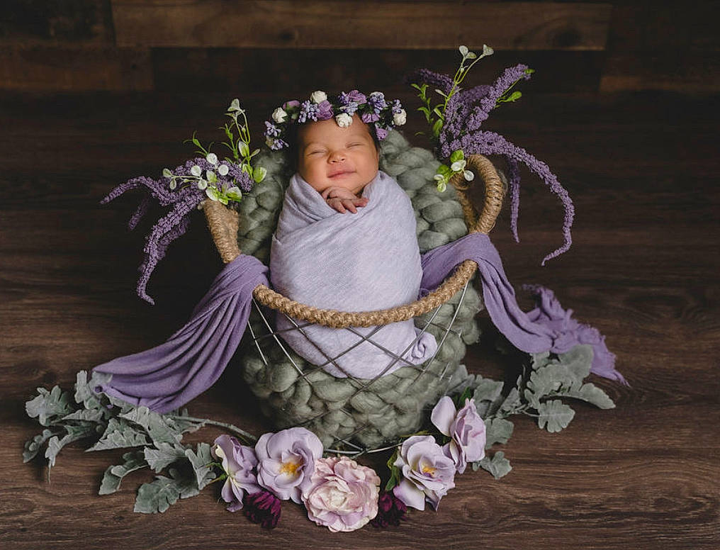 Teagan joined the competition — help win amazing prizes! baby, baby_toddler_clothing, bouquet, chair, cut_flowers, eye, fawn, flash_photography, flower_arranging, hair_accessory, headgear, headpiece, headwear, human_body, iris, jewellery, person, petal, plant, purple