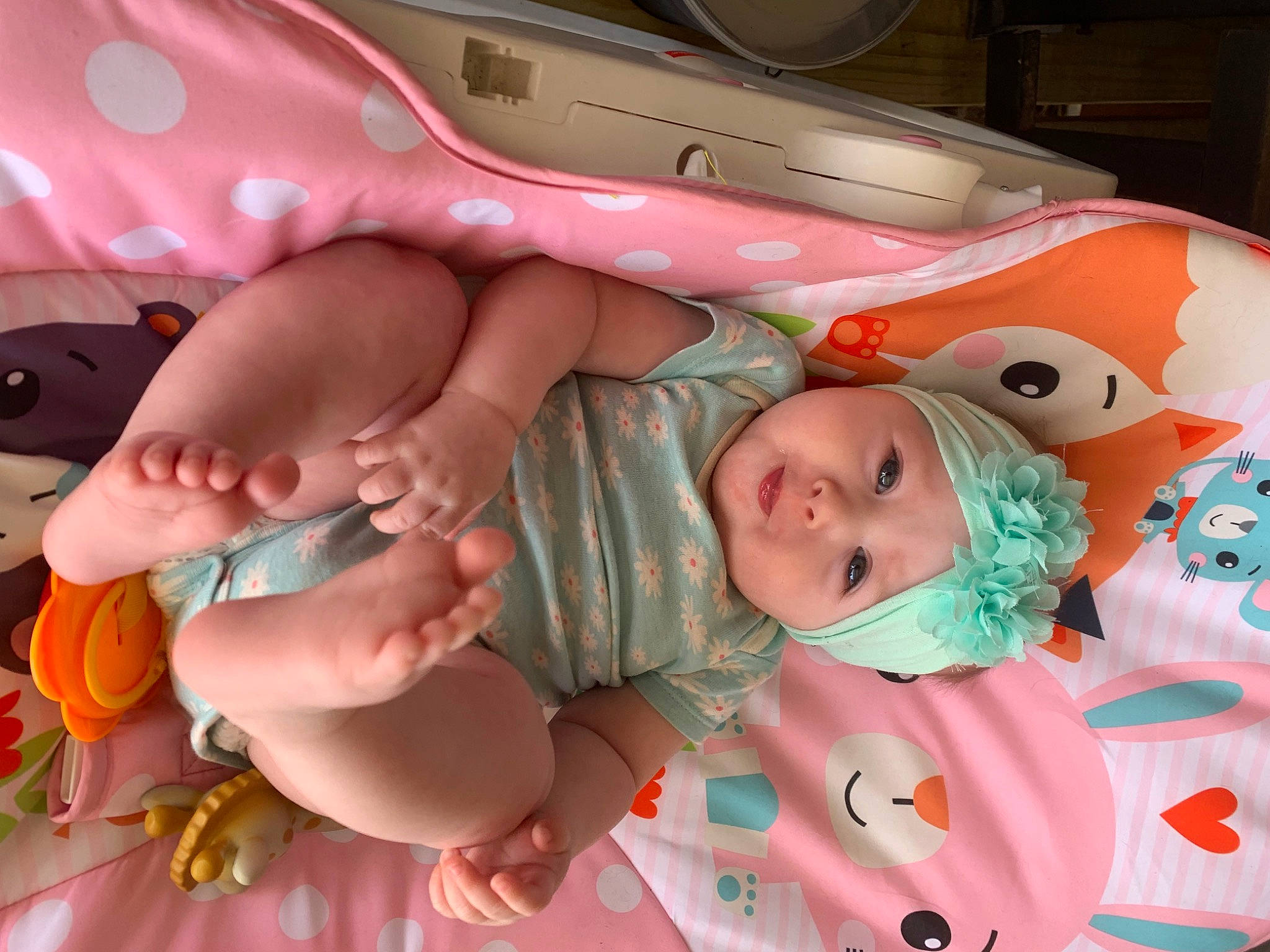 Lily Grace is registered to the contest to win money with this photo: baby, baby_products, baby_toddler_clothing, child, comfort, event, eye, facial_expression, finger, foot, headwear, human_body, laundry_room, linens, mouth, nail, person, pink, room, skin