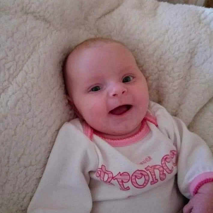 Malena is registered to the contest to win money with this photo: apparel, baby, babywear, blanket, child, clothing, comfort, cozy, cute, face, happy, indoors, infant, newborn, person, portrait, resting, smiling, soft, warm