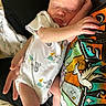 Asher joined the competition — help win amazing prizes! baby, newborn, sleeping, onesie, elephant, duck, person, arm, hand, tshirt, graphic, colorful, dove, pattern, indoor, cozy, peaceful, skin, infant, cuddle