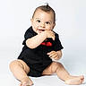 Gabriel joined the competition — help win amazing prizes! baby, child, infant, portrait, smiling, happy, sitting, studio, indoors, black_outfit, red_detail, barefoot, cute, face, eyes, hair, hands, legs, white_background, photography