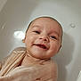 baby, blanket, child, closeup, cute, expression, face, happy, indoors, infant, lying, newborn, peaceful, portrait, skin, smiling, soft, tub, water, wrapped