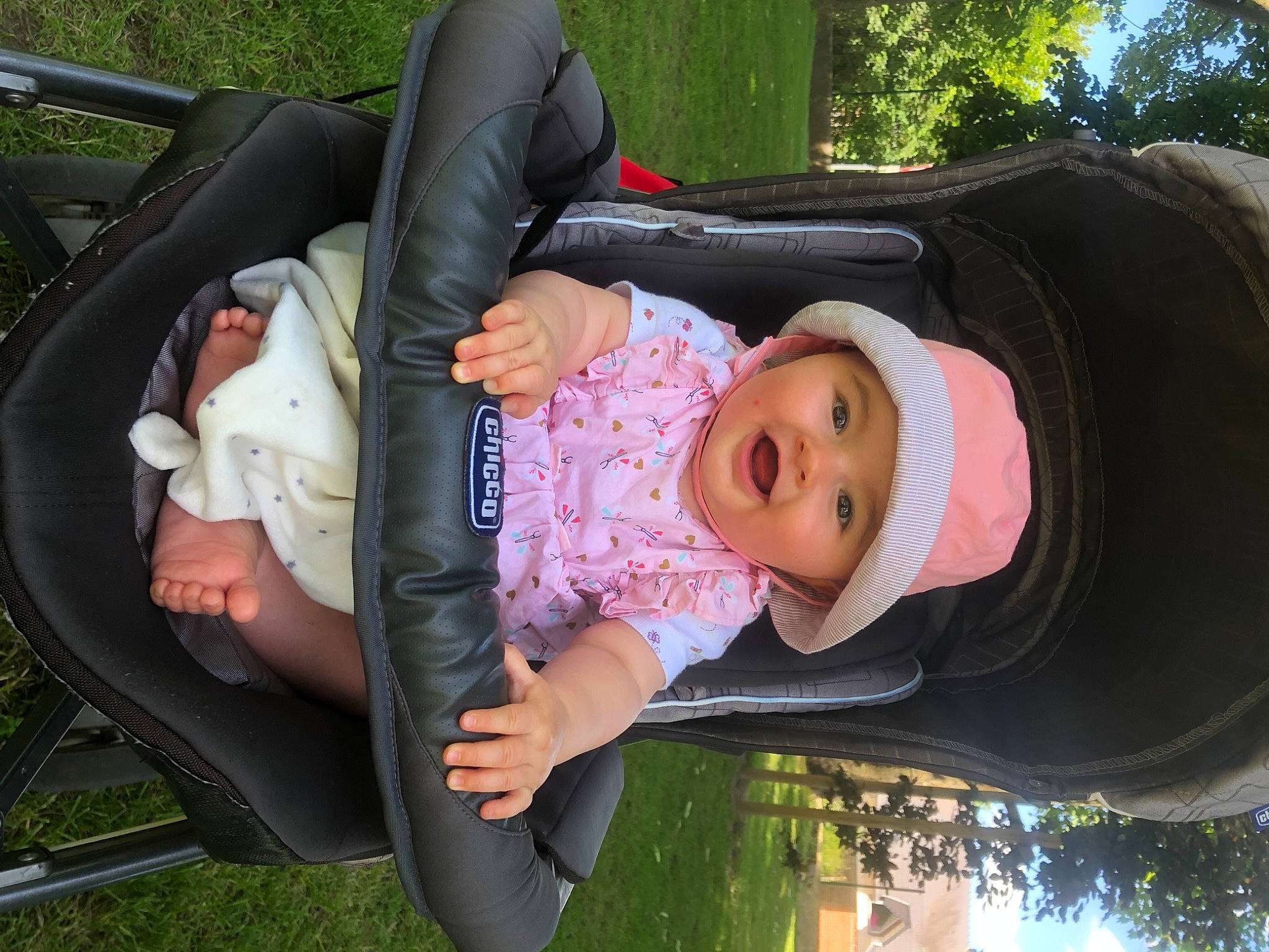 Illyana a rejoint le concours — aidez-le/la à gagner de superbes lots ! baby, baby_carriage, baby_products, baby_toddler_clothing, black, child, comfort, facial_expression, fun, grass, green, hat, headwear, human_body, lap, leaf, leisure, person, plant, sitting