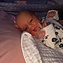 Emerson is registered to the contest to win money with this photo: baby, newborn, blanket, pacifier, infant, sleeping, clothing, hand, face, bed, soft, pink, white, cozy, cute, lying_down, indoors, portrait, child, resting