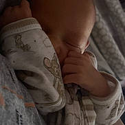 Emerson joined the competition — help win amazing prizes! baby, sleeping, pajamas, animal_print, hand, face, head, cozy, resting, infant, child, soft, fabric, floral, pattern, closeup, peaceful, newborn, cuddle, indoors