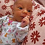 Emerson joined the competition — help win amazing prizes! baby, newborn, infant, pillow, onesie, animal_print, pink, floral_pattern, hand, face, eyes, sleepwear, cute, soft, resting, indoors, child, portrait, newborn_clothing, cozy