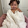 toddler, child, smiling, towel, indoor, pink, hair_tied, cute, happy, baby, face, person, portrait, sitting, blanket, wrapped, door, room, skin, fun