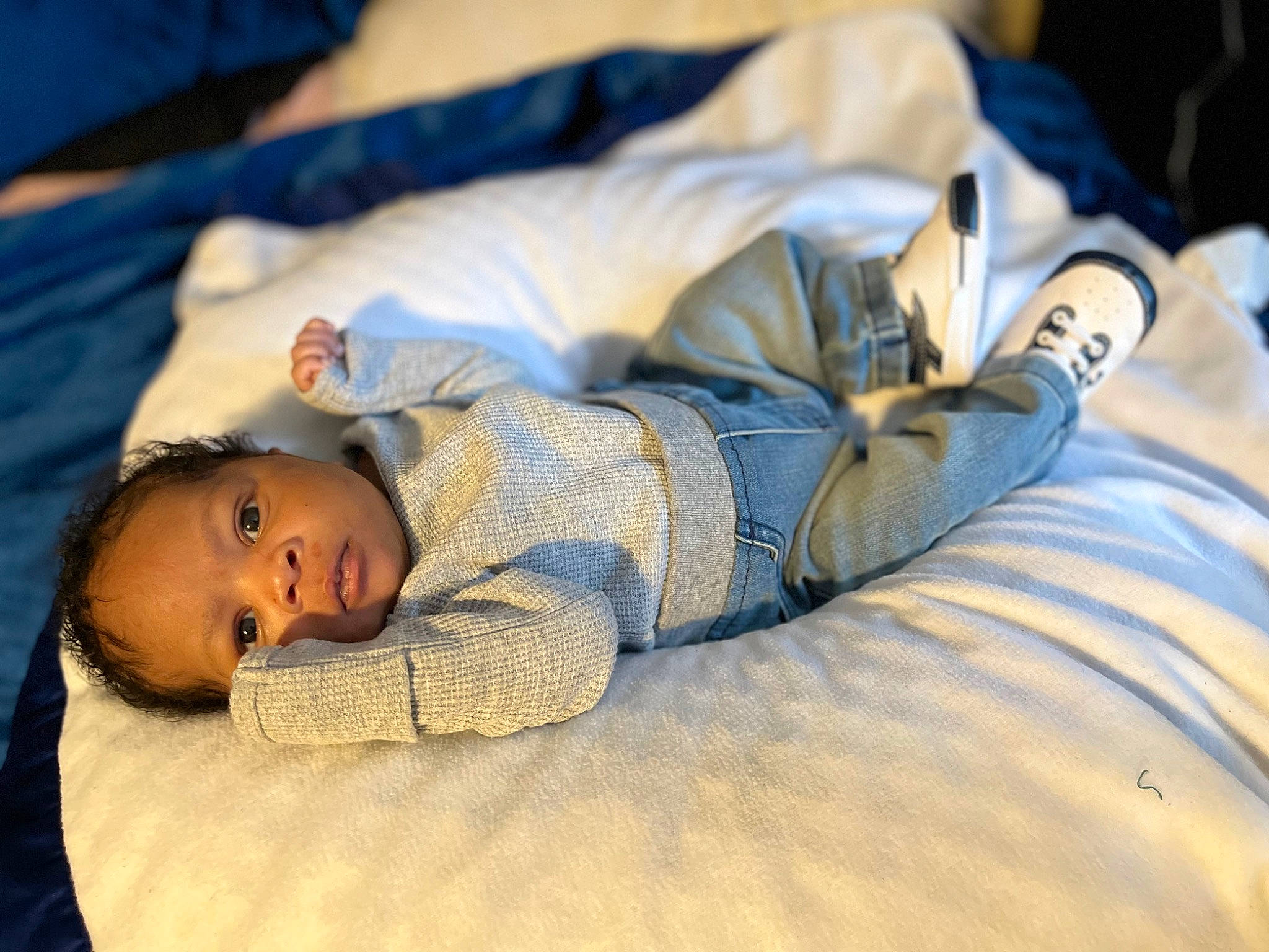 Zane is registered to the contest to win money with this photo: baby, bed, bed_sheet, bedding, bedtime, child, comfort, flooring, fun, fur, human_body, human_leg, linens, nap, person, room, sitting, sleep, textile, toddler