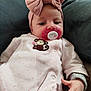 accessories, baby, blanket, bodypart, bonnet, cap, clothing, couch, cushion, face, finger, furniture, hand, hat, head, homedecor, newborn, person, photography, portrait
