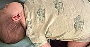 Liam joined the competition — help win amazing prizes! baby, infant, sleeping, onesie, animal_print, blanket, cushion, soft_fabric, indoor, resting, child, person, head, arm, leg, skin, home, comfort, peaceful, nap
