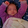 baby, blanket, child, comfort, cozy, cute, face, hands, head, indoors, infant, nap, peaceful, pillow, purple_clothing, resting, sleeping, soft, star_pattern, warm