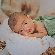 Ignatius is registered to the contest to win money with this photo: baby, infant, face, eyes, blanket, basket, towel, skin, head, lying_down, cute, portrait, soft, newborn, resting, indoors, closeup, peaceful, child, wrapped