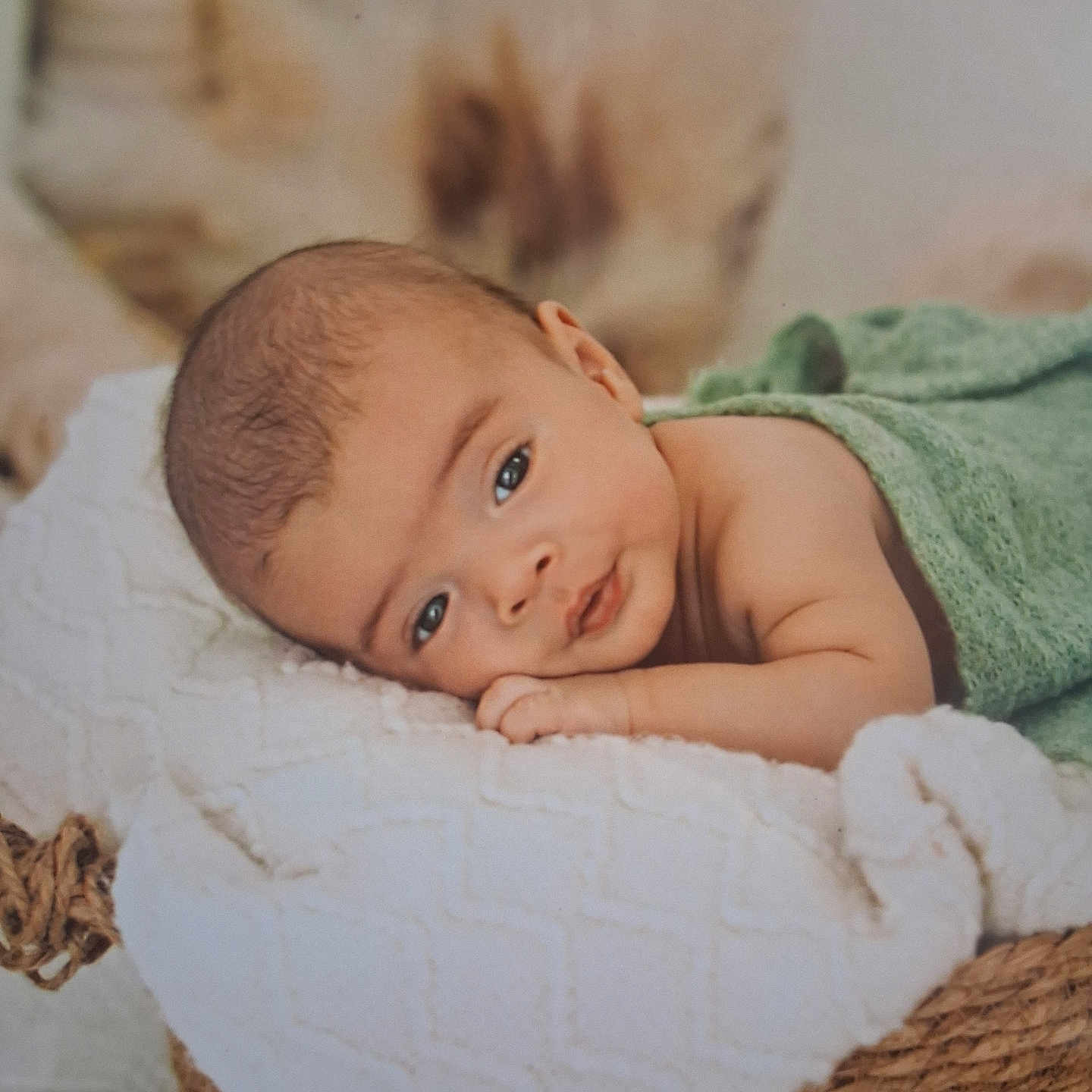Ignatius is registered to the contest to win money with this photo: baby, infant, face, eyes, blanket, basket, towel, skin, head, lying_down, cute, portrait, soft, newborn, resting, indoors, closeup, peaceful, child, wrapped